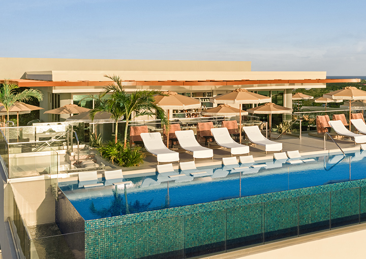 a pool with lounge chairs and umbrellas
