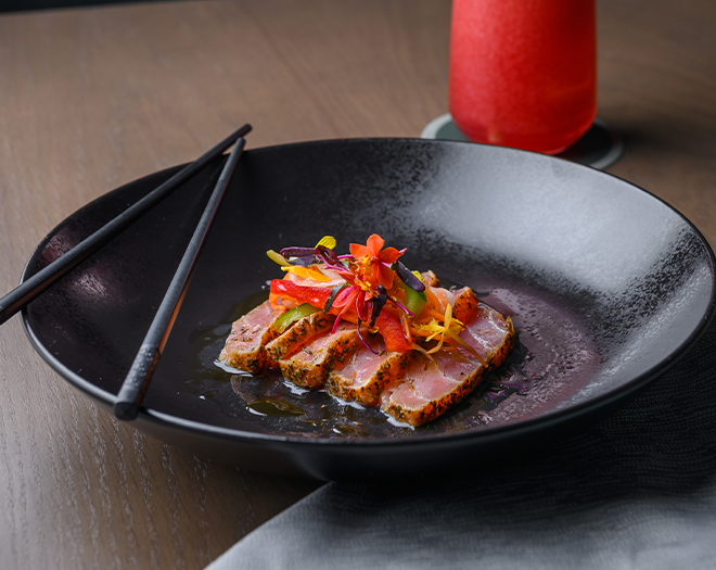 a plate of food with chopsticks