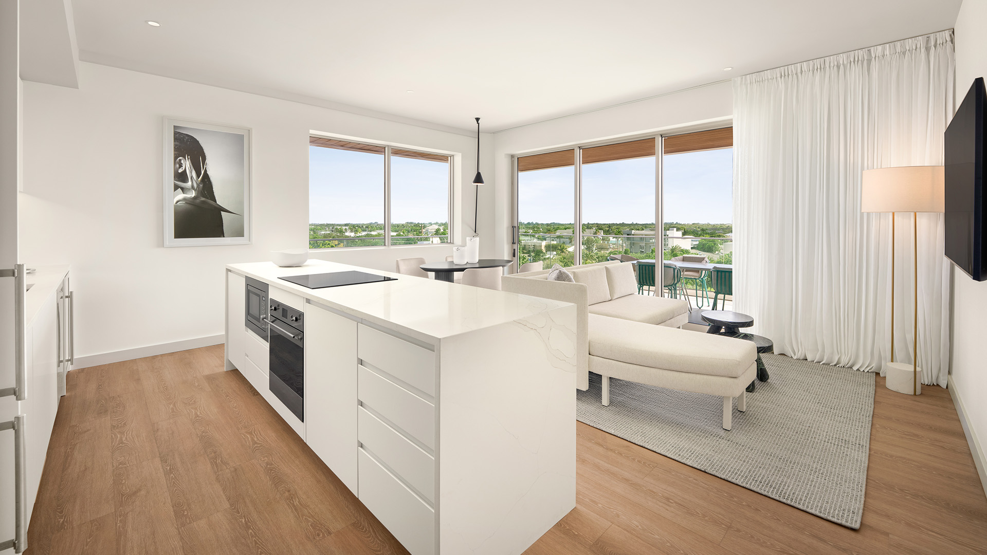 a kitchen and living room with large windows