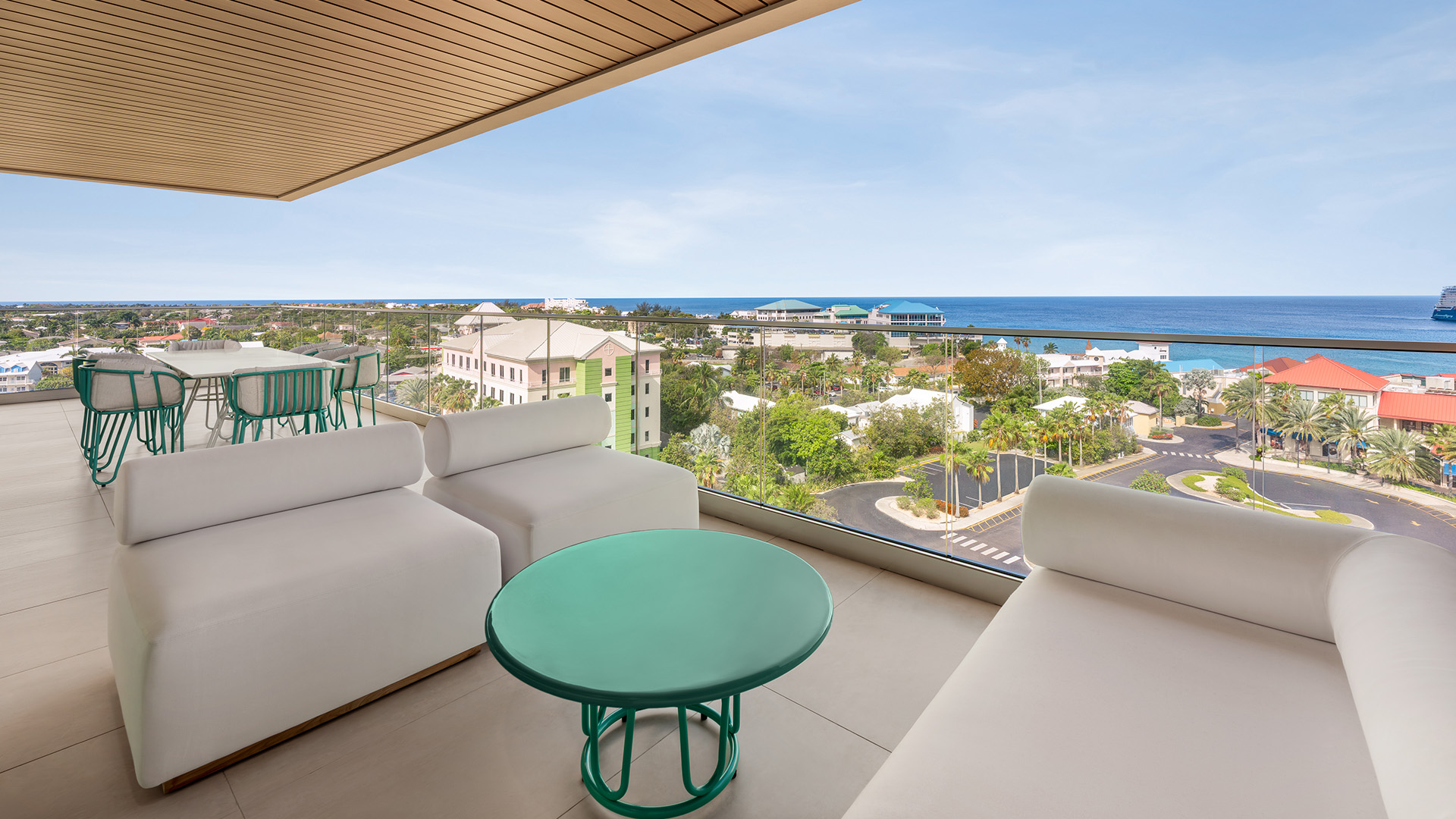 a balcony with a view of the ocean and a city