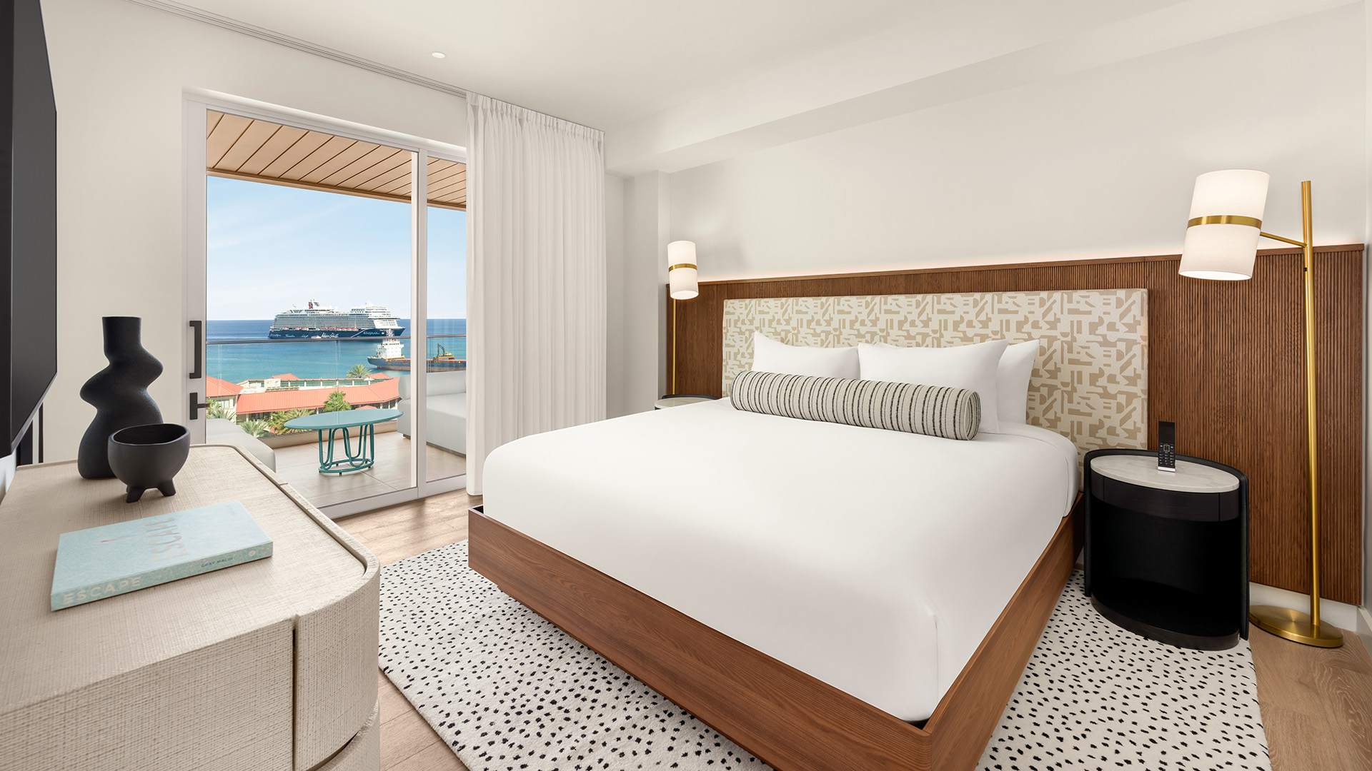 a bedroom with a bed and a glass door