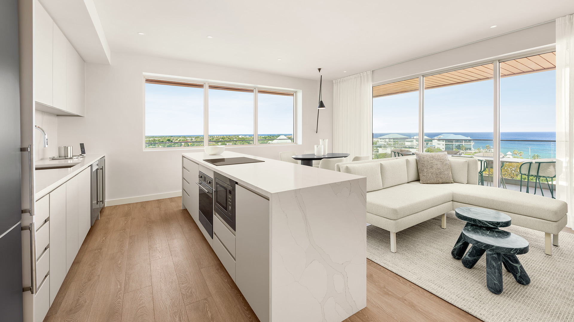 a kitchen and living room with a couch and a view of the city