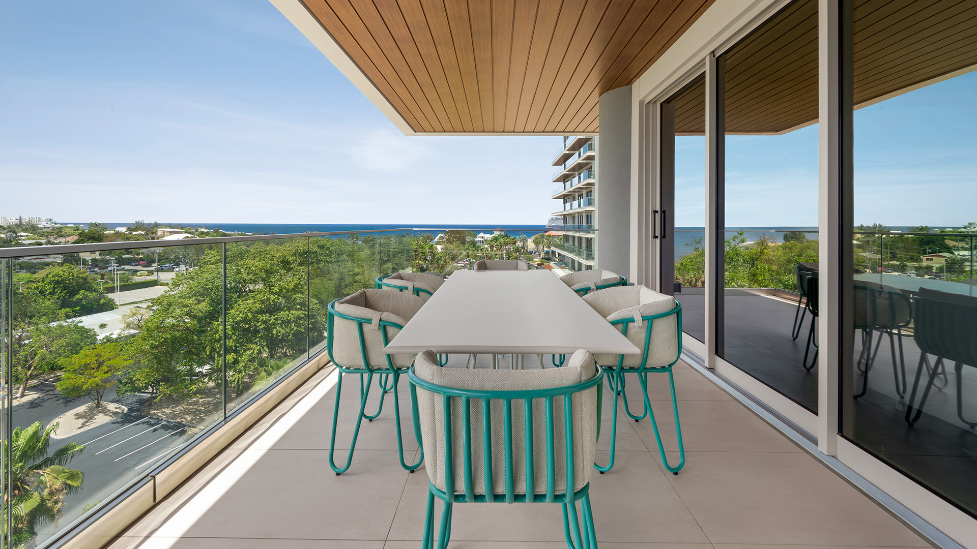 a table and chairs on a balcony overlooking trees and water
