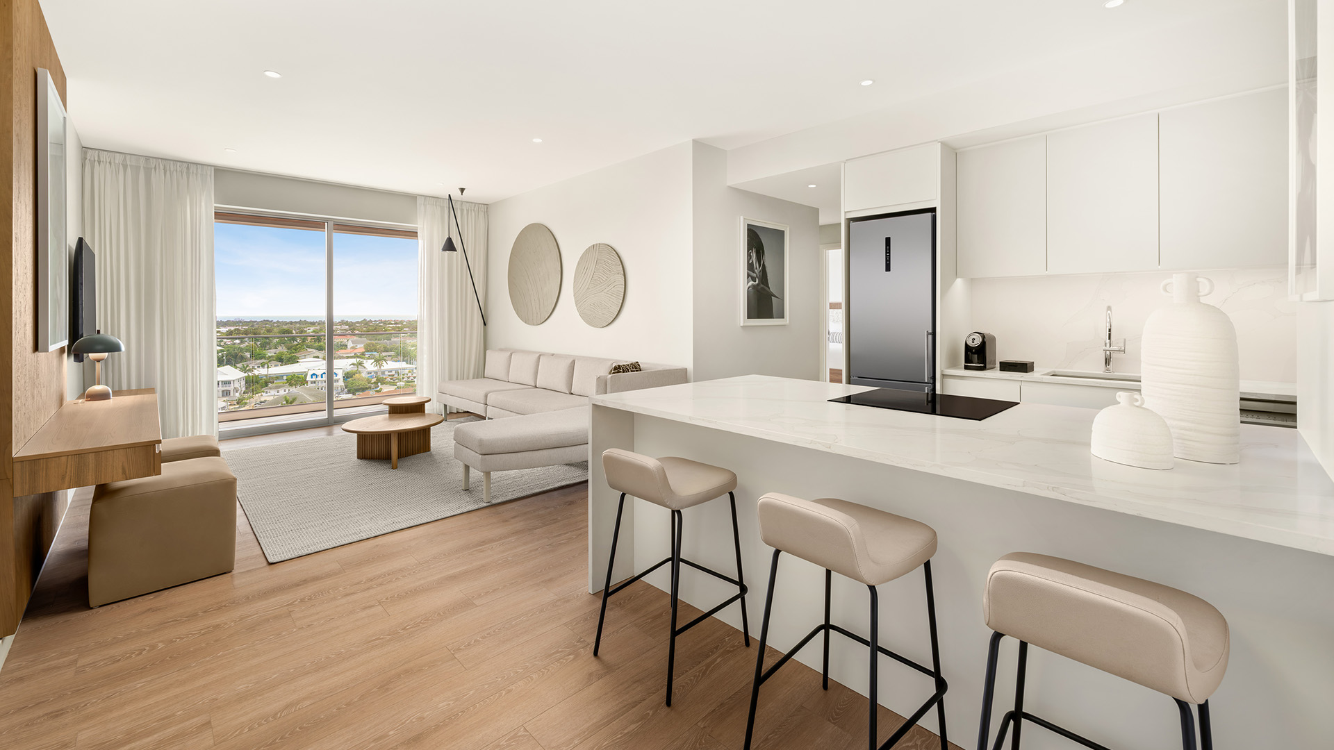 a kitchen and living room with a view of a city