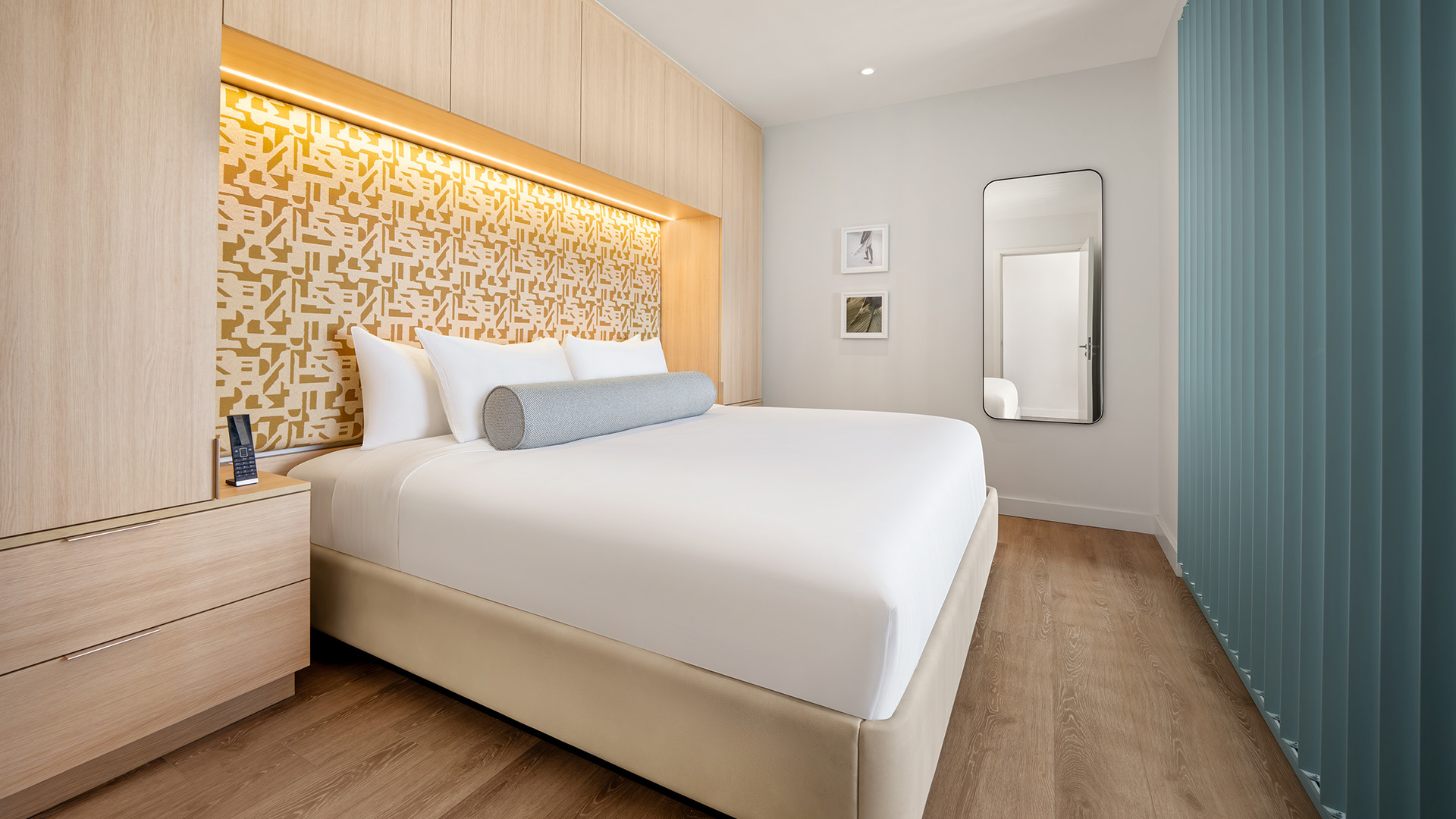 a bed with a mirror in the background