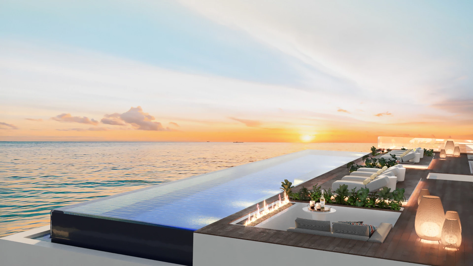 a pool with a deck and chairs and a sunset