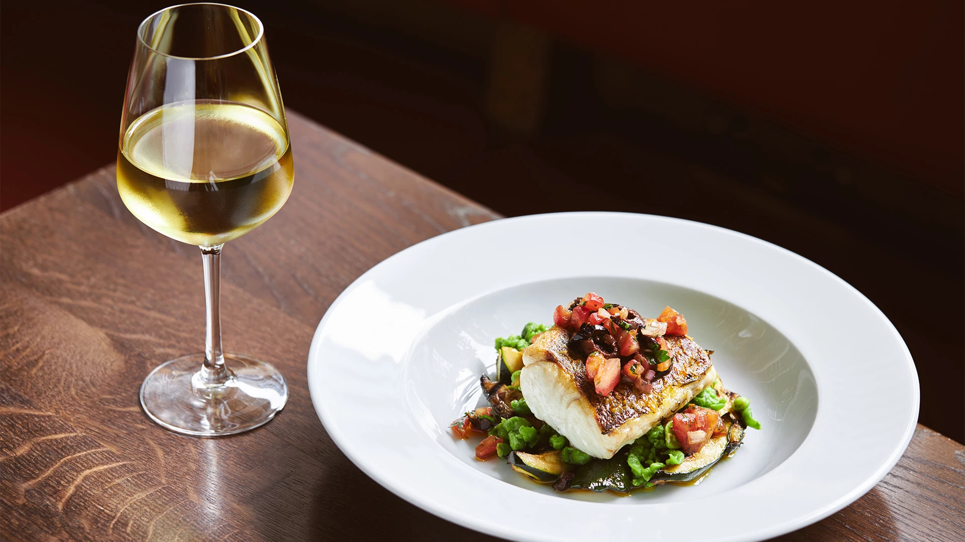 a plate of food and a glass of wine