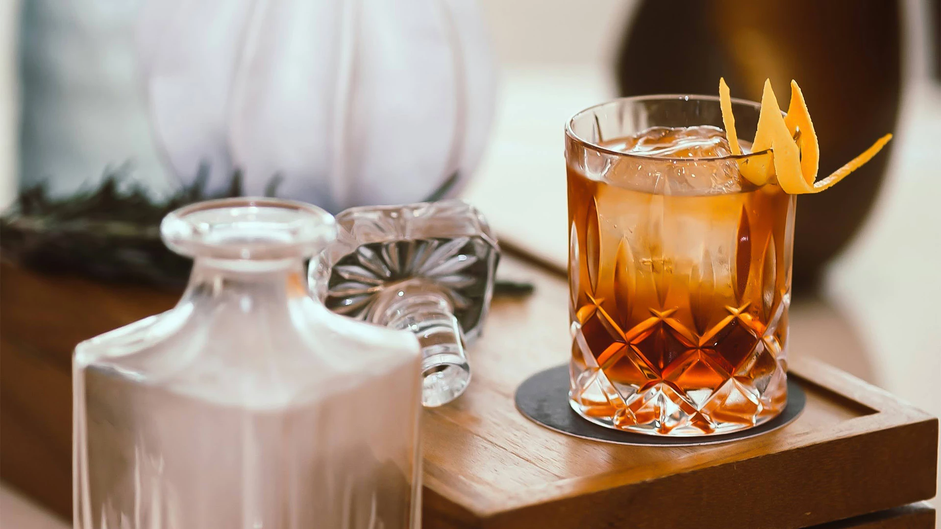 a glass with a drink and a slice of orange peel