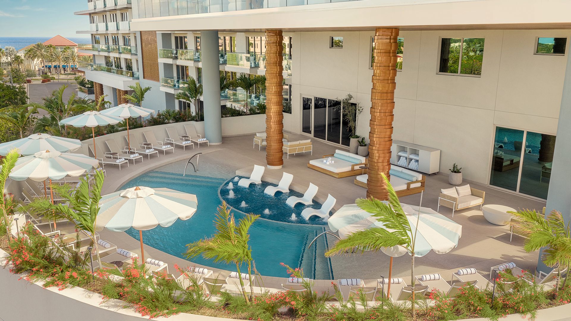 a pool with umbrellas and chairs in a hotel