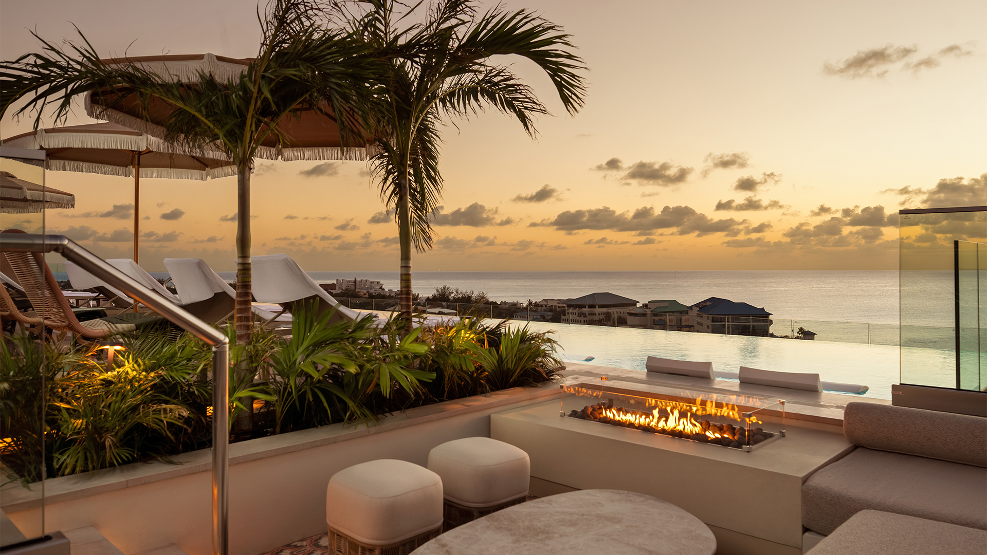 a fire pit with a view of the ocean and a beach