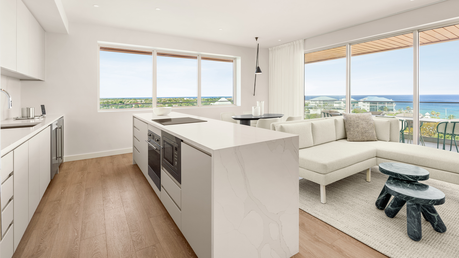 a kitchen and living room with large windows