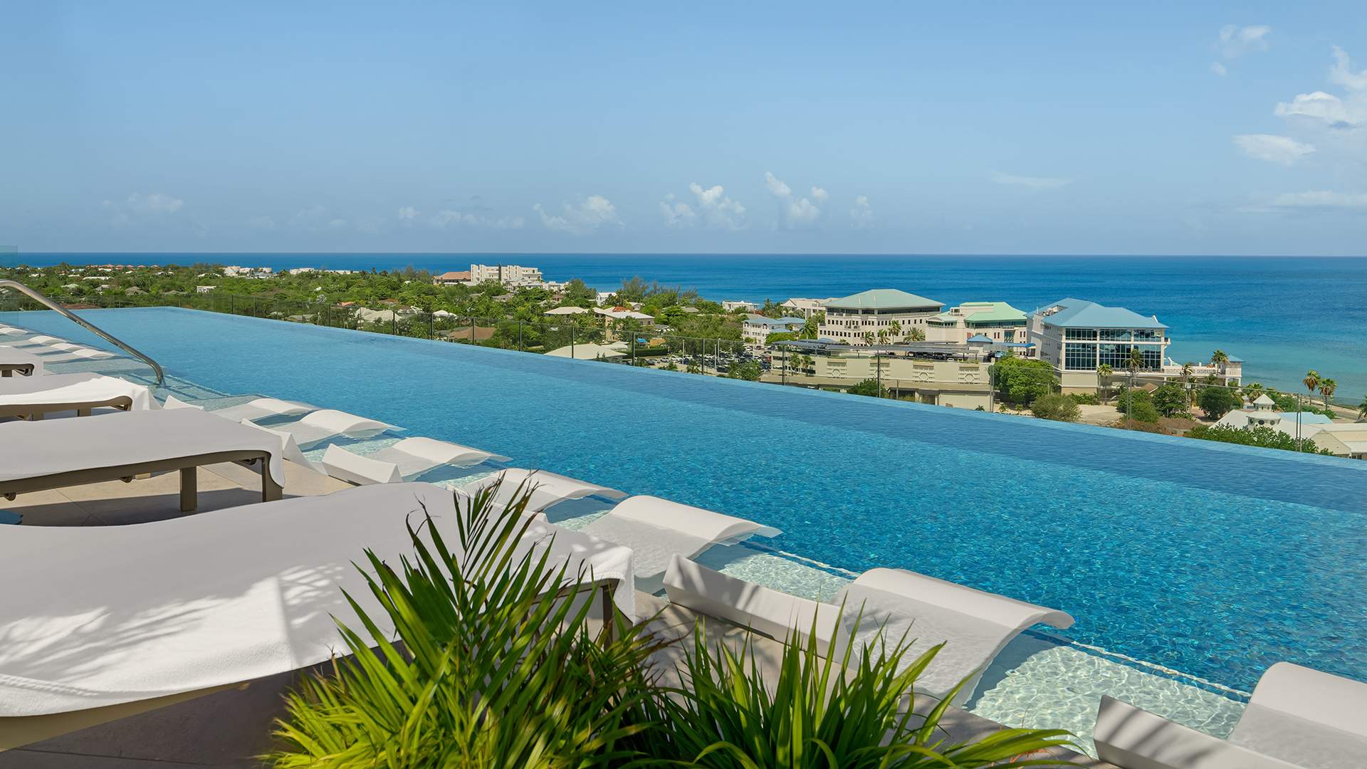 a pool with a view of the ocean and buildings