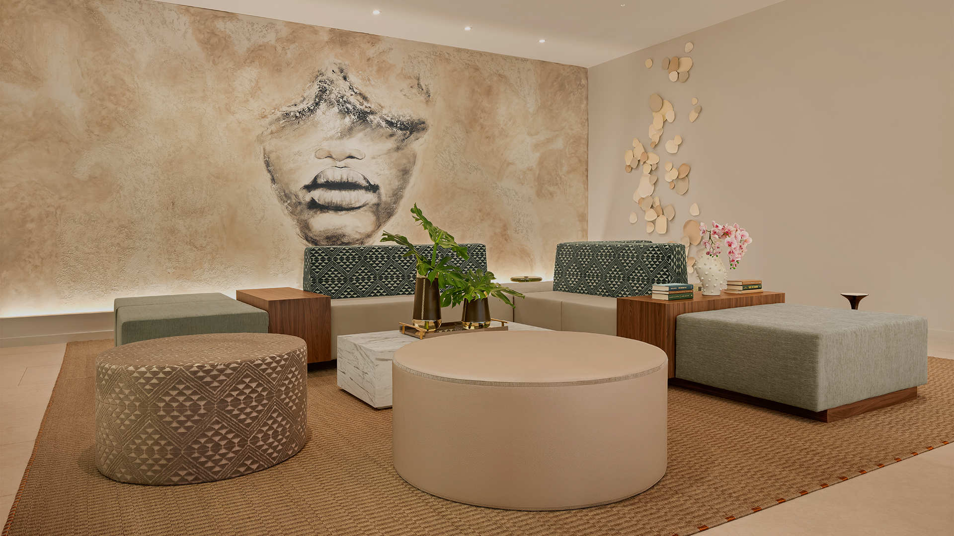 a room with a large round table and couches