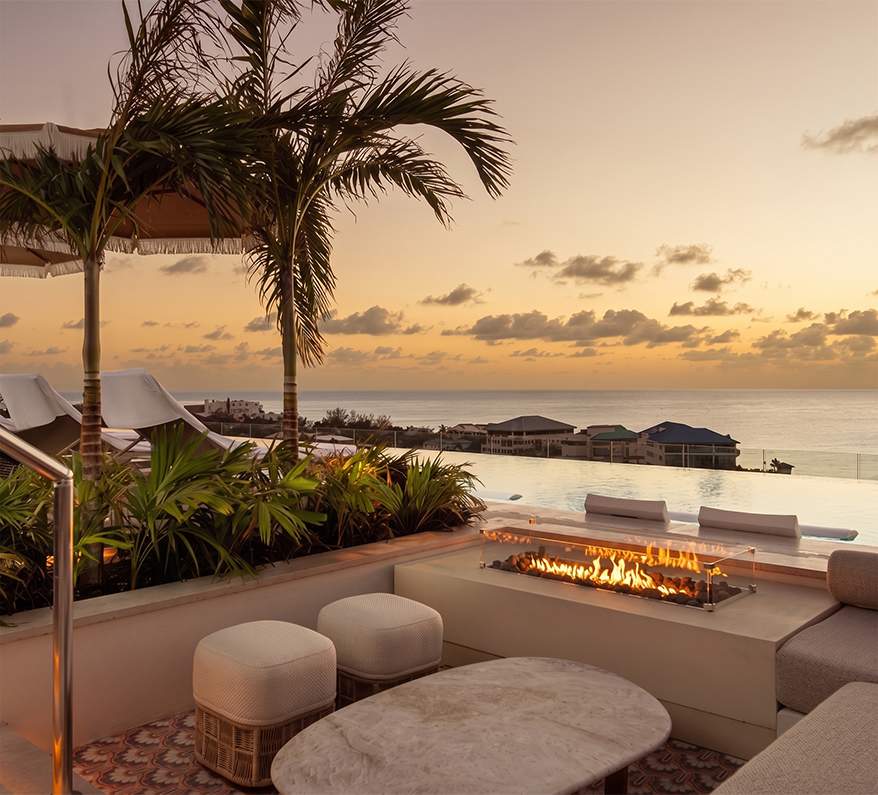 a fire pit with a view of the ocean and a beach