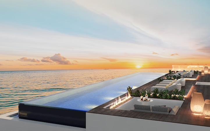 a pool with a deck and chairs on top of it