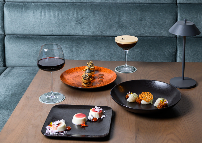 a table with plates of food and drinks