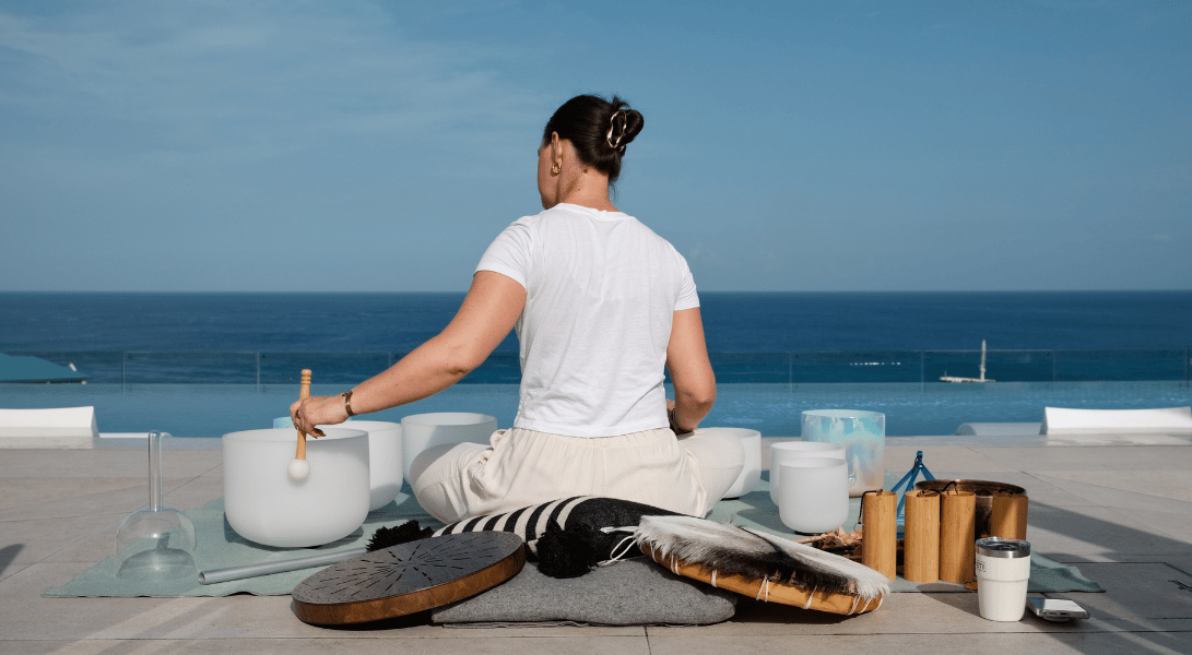 a woman sitting on a balcony with a large body of water