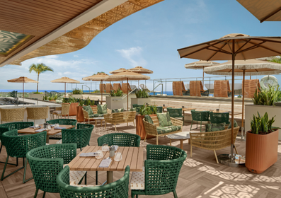 a patio with chairs and umbrellas