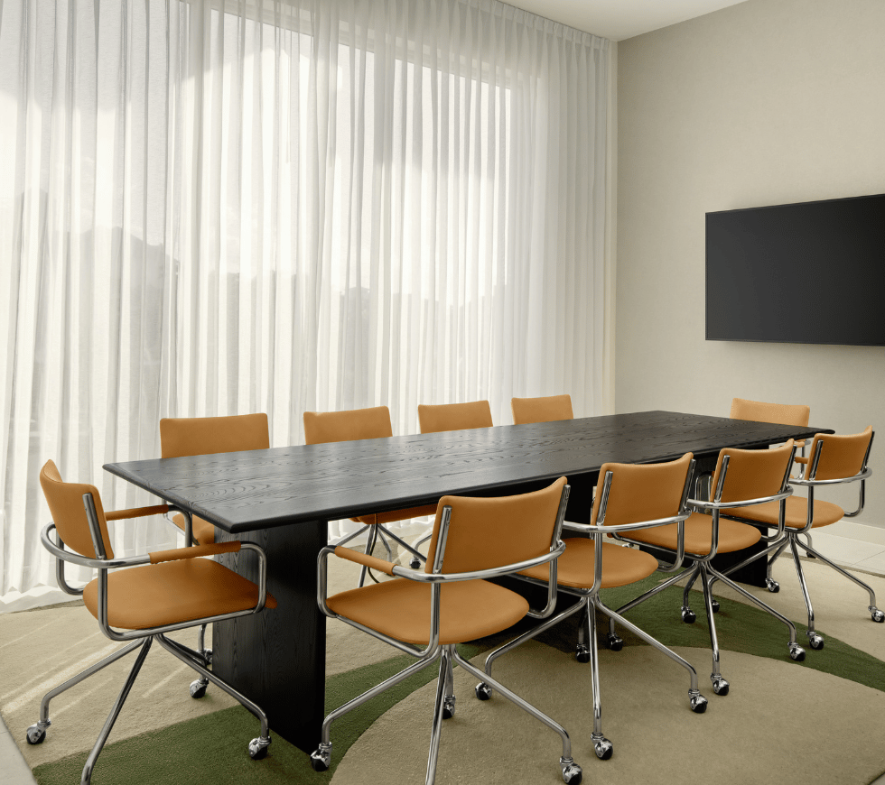 a table with chairs in a room with a television