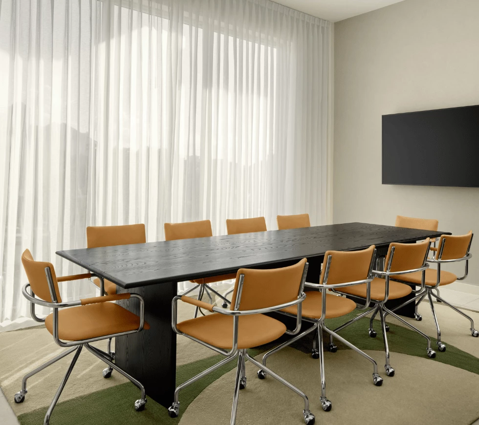 a table with chairs in a room with a television