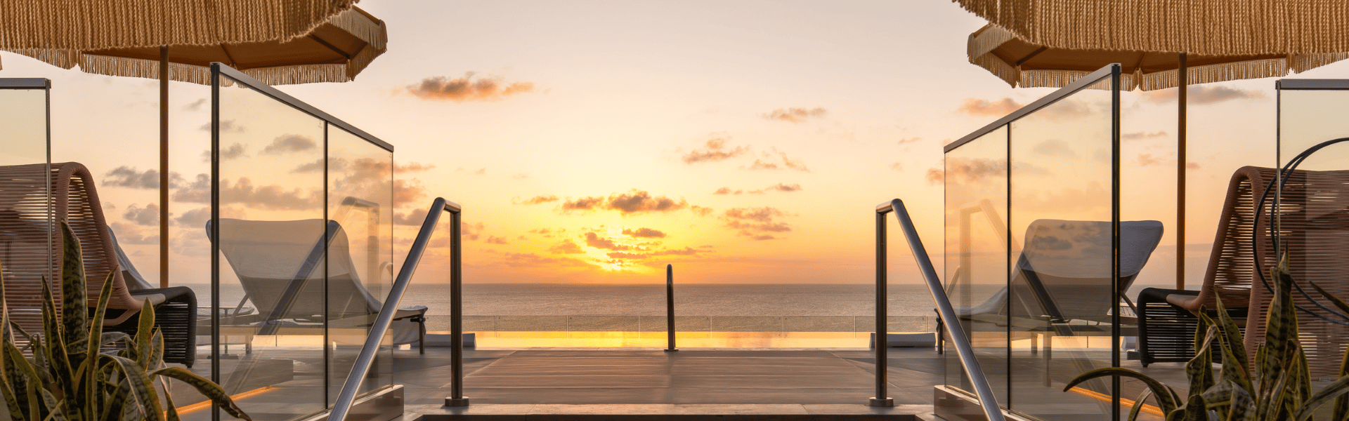 a pool with a sunset in the background