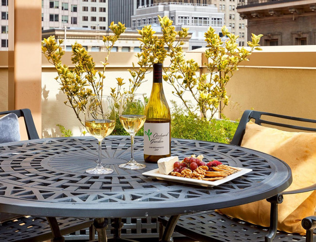 Wine, wine glasses and cheese plate on table