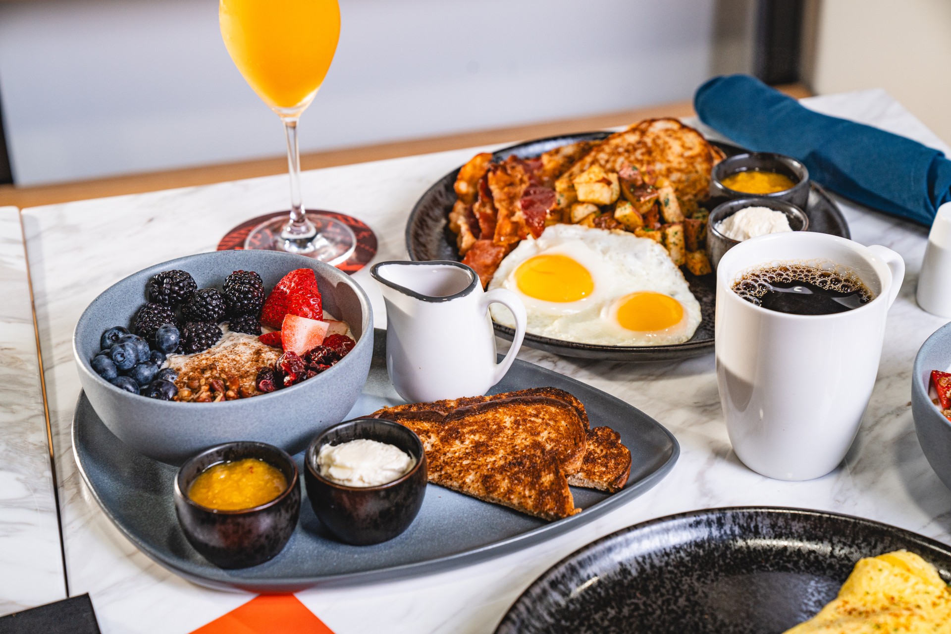 a plate of food with a drink and a glass of juice
