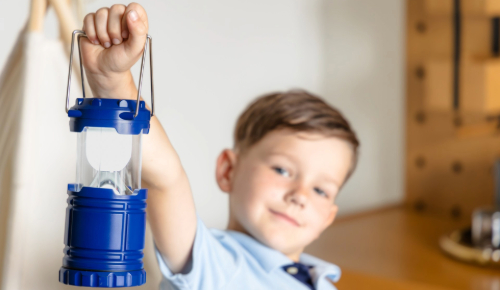 a boy holding a lantern