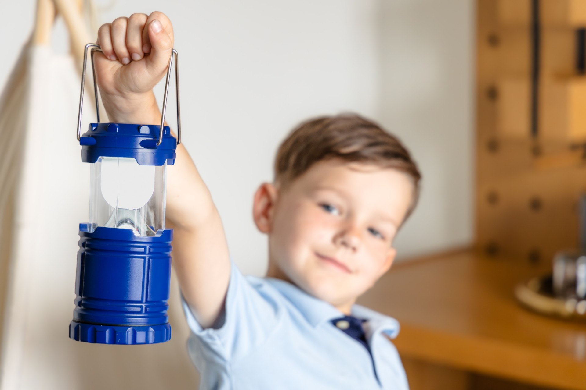 a boy holding a lantern