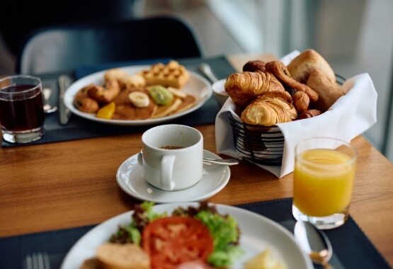 a breakfast table with food and drinks