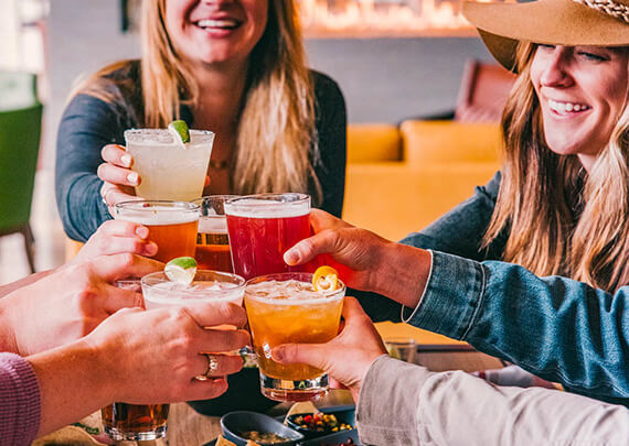 group fo gals toasting with margaritas