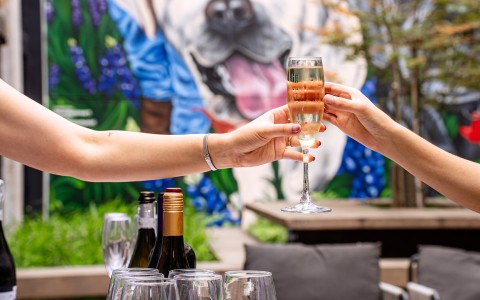 a person holding a glass of champagne