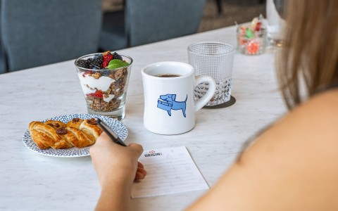 a person writing on a plate of food