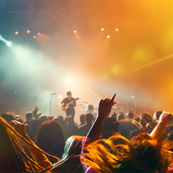 a crowd of people with their hands up in the air