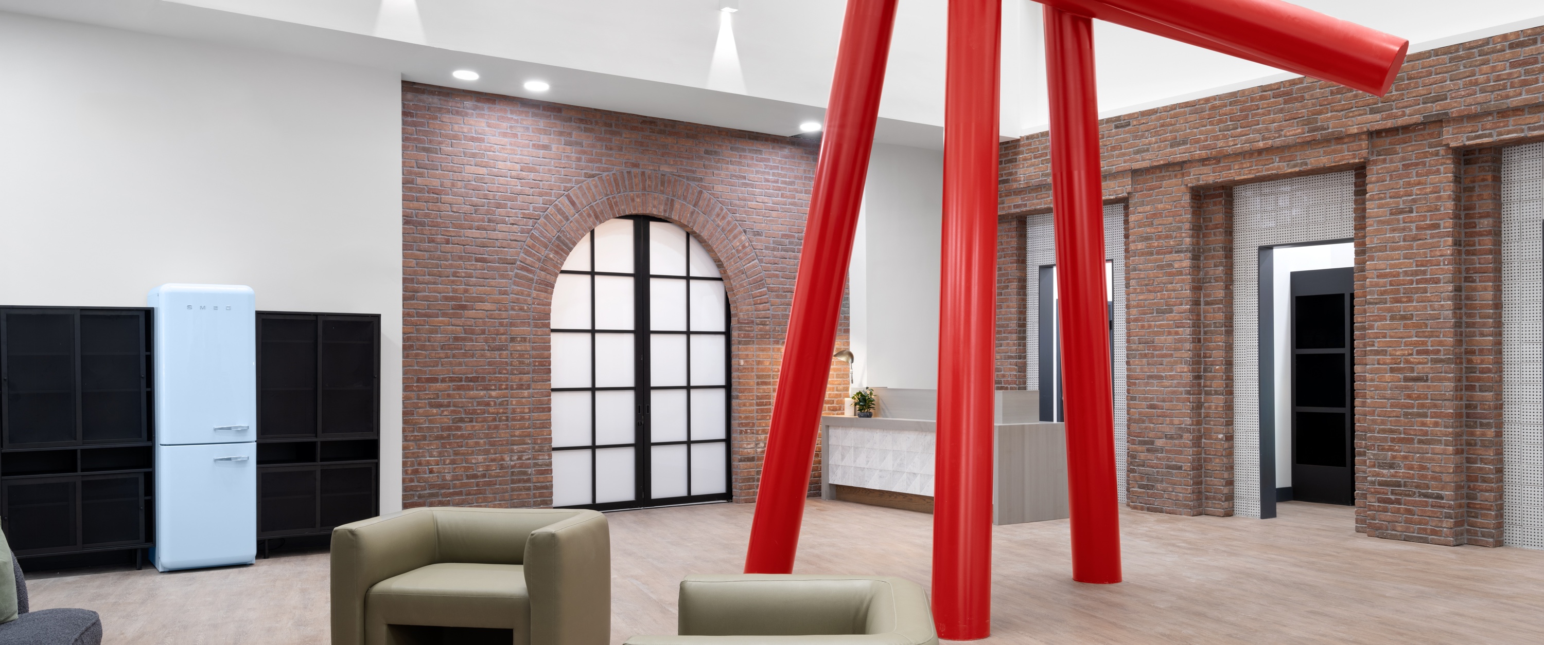 a room with red columns and a brick wall