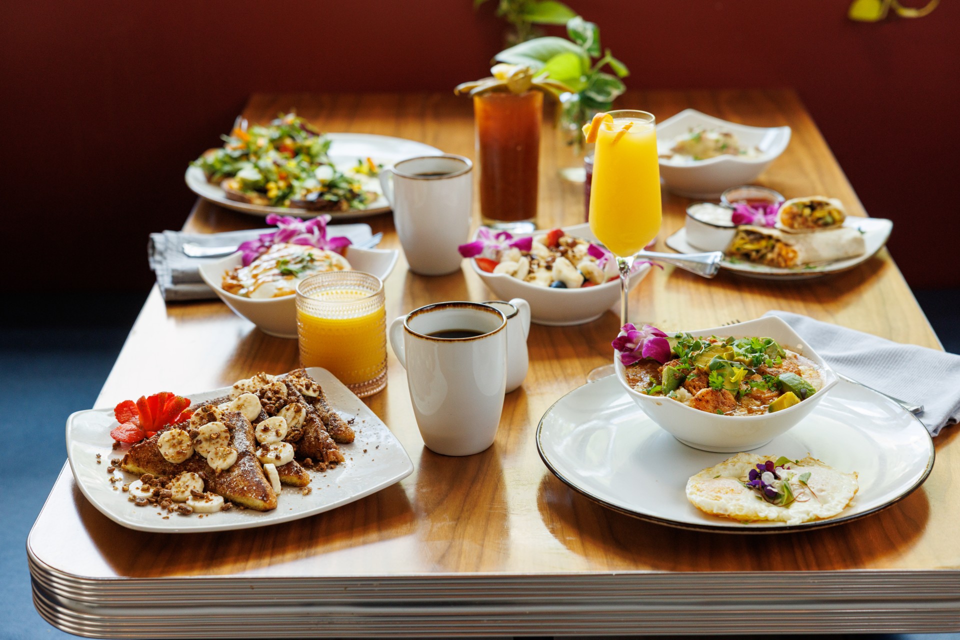 a table with plates of food and drinks