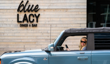 a woman in a blue car