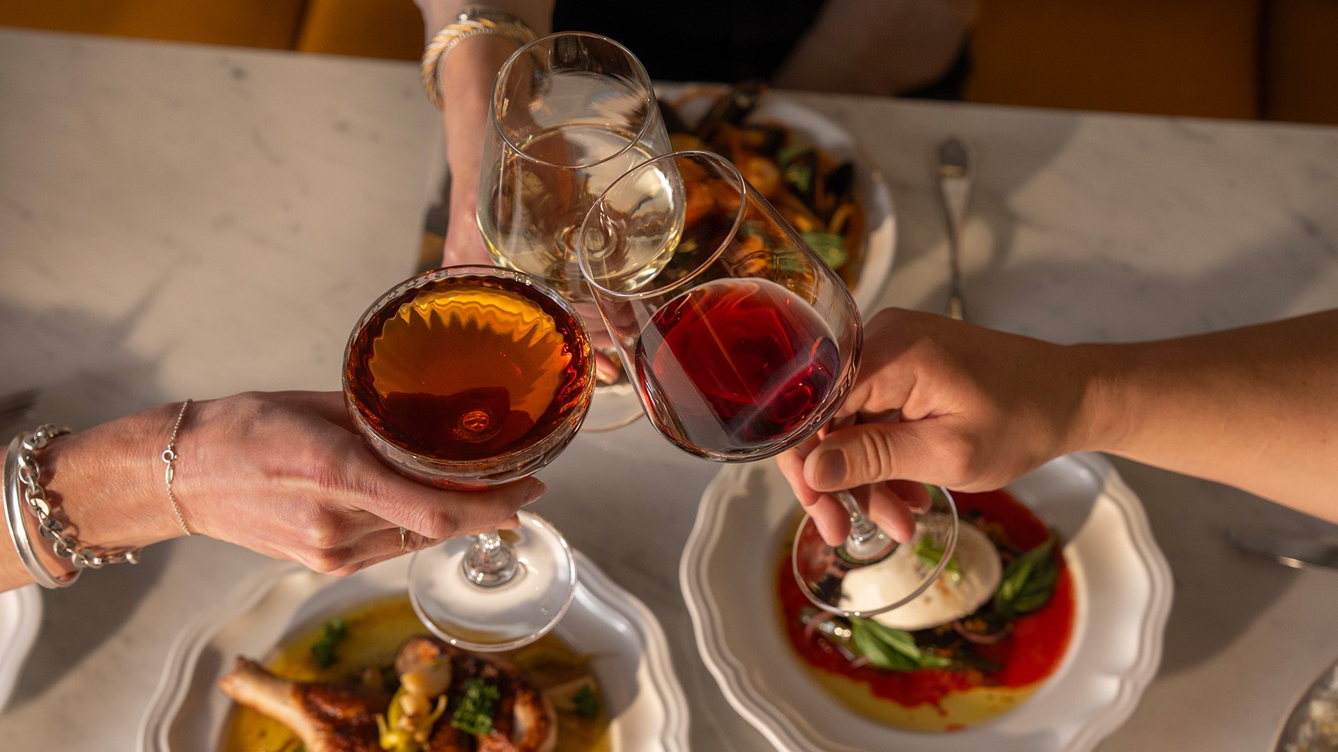 a group of people holding wine glasses
