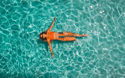 woman floating in pool water