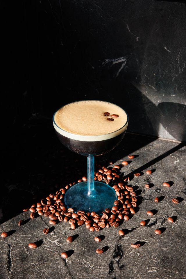 a glass of coffee with a brown liquid in it