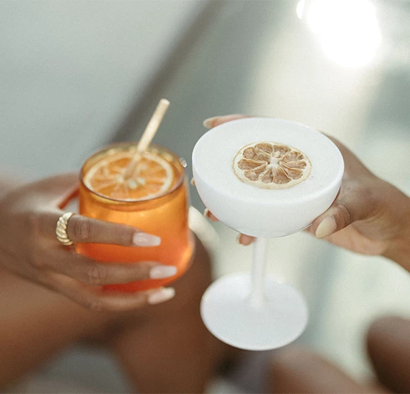 a pair of hands holding drinks