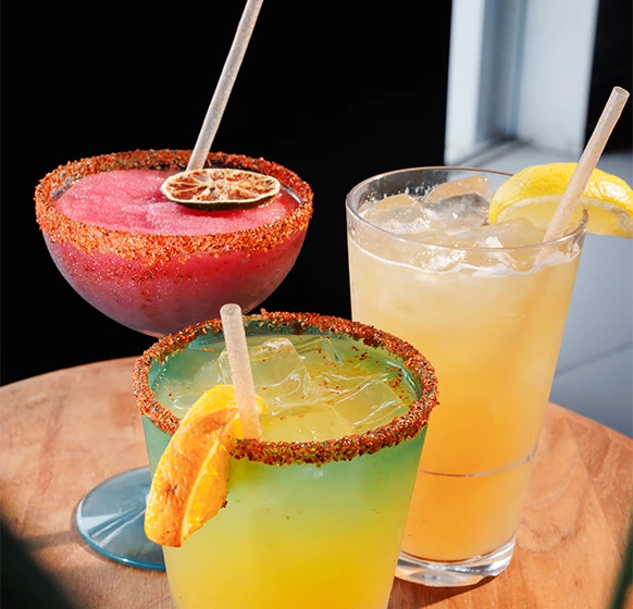 a group of colorful drinks on a table