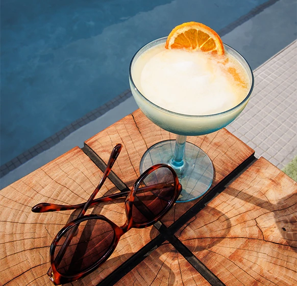 a drink and sunglasses on a table