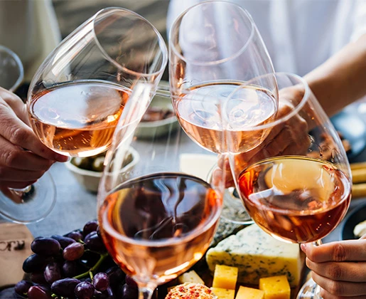 a group of people clinking wine glasses