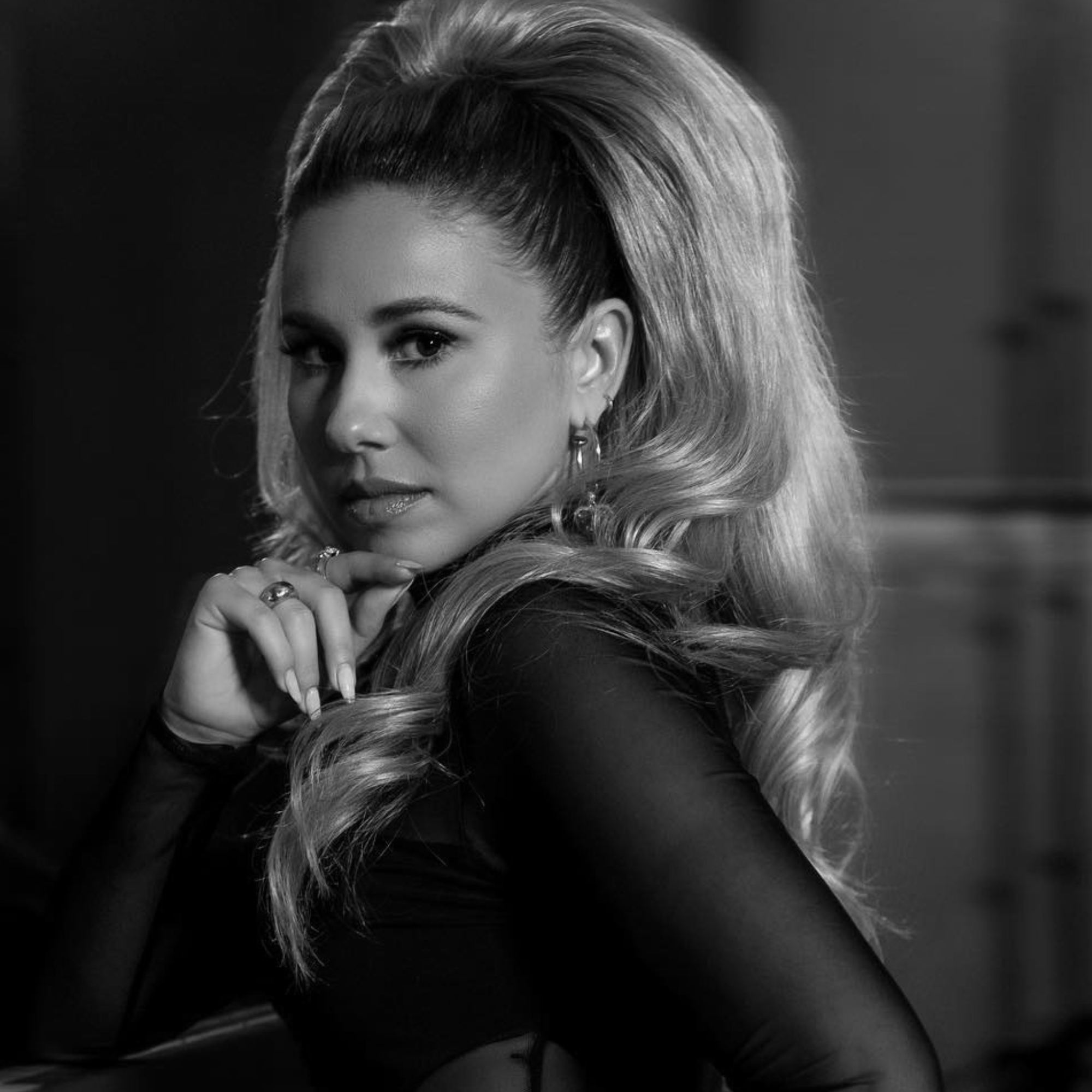 a woman with long hair and a ponytail