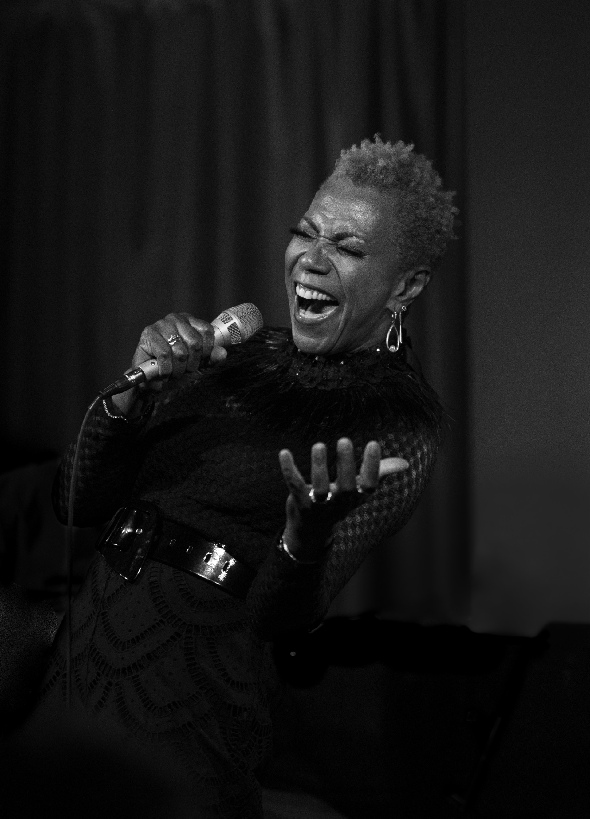 a woman singing into a microphone