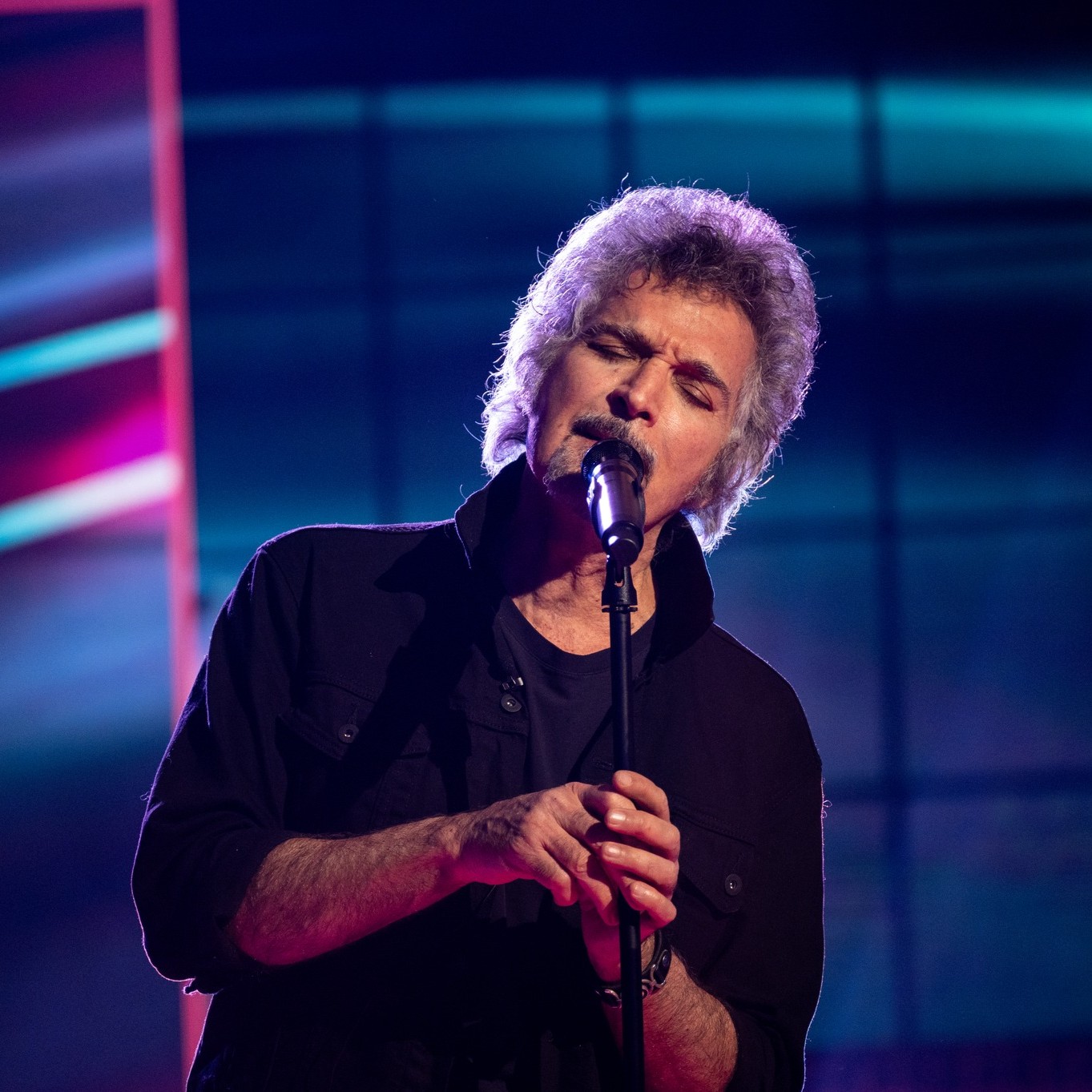 a man singing into a microphone
