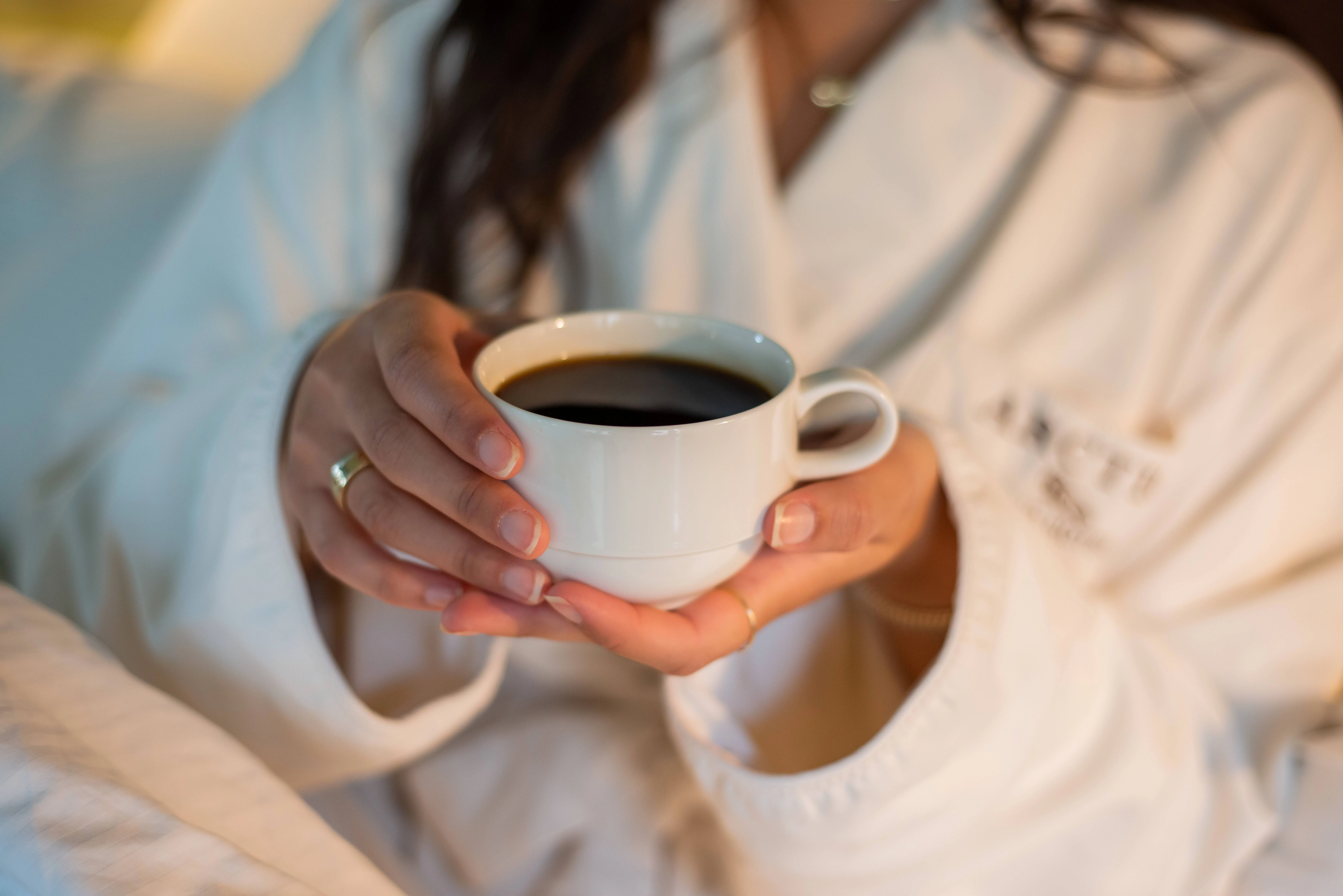 a woman holding a cup of coffee