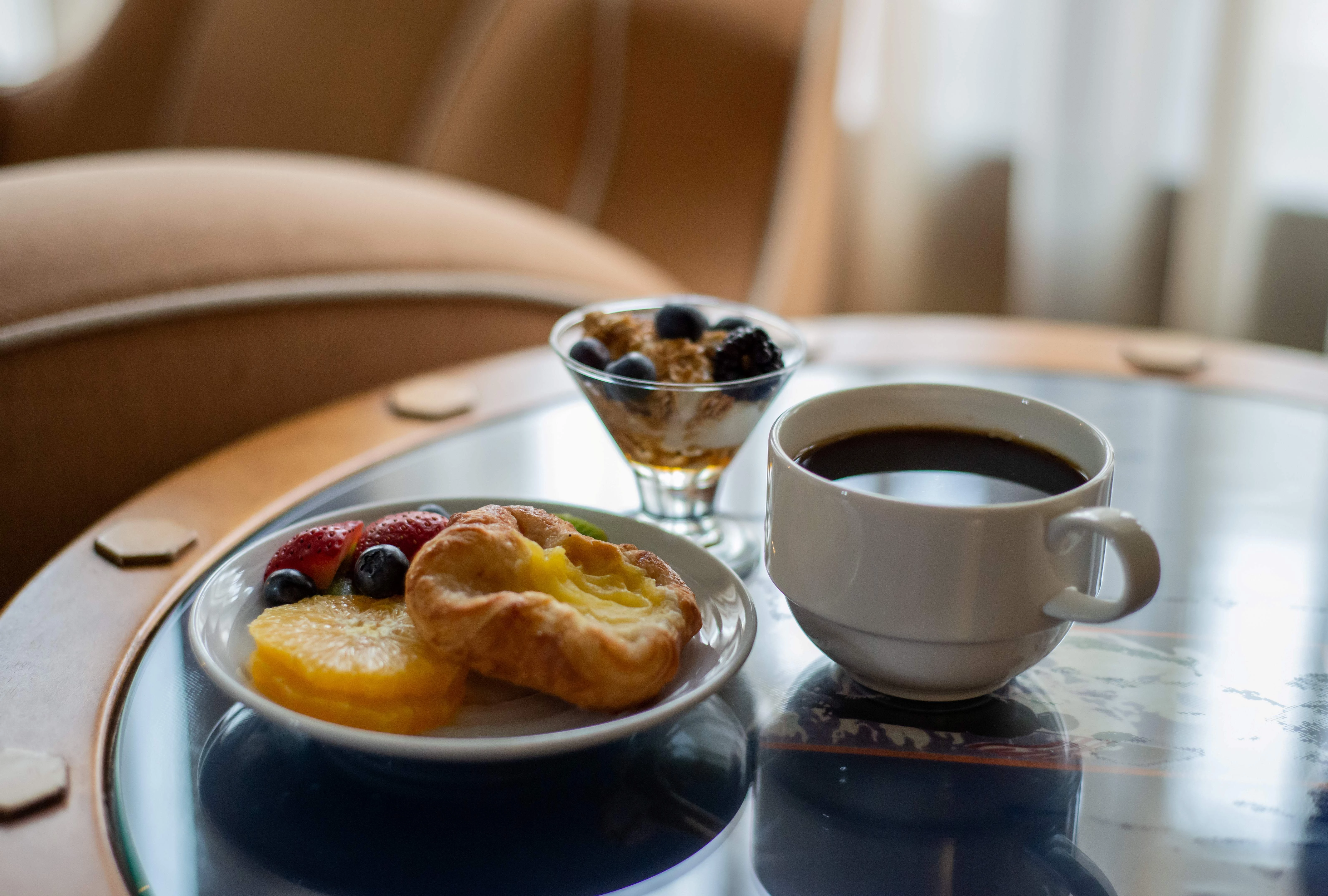 a plate of food and a cup of coffee on a table
