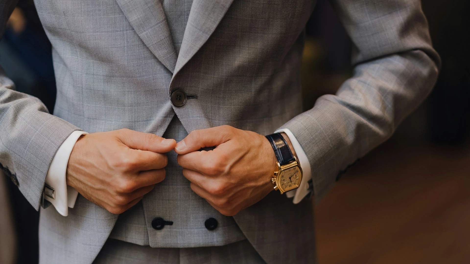 a man buttoning his jacket